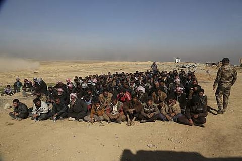 Displaced men who fled their homes due to fighting between Iraqi security forces and Islamic State militants wait for a security check at an Iraqi Army base, west of Mosul, Iraq, Sunday, Feb. 26. 2017. (Photo | AP)