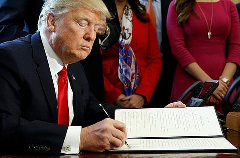 U.S. President Donald Trump signs an executive order rolling back regulations from the 2010 Dodd-Frank law on Wall Street reform at the White House in Washington, U.S. February 3, 2017. REUTERS