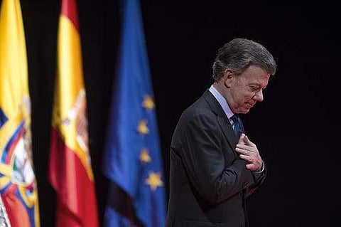 Nobel Peace Prize laureate and Colombia's President Juan Manuel Santos acknowledges applauds after receiving the Nueva Economia Forum award at the Royal theater in Madrid. Colombia's chief prosecutor said Tuesday, feb. 7, 2017, President Juan Manuel Santo