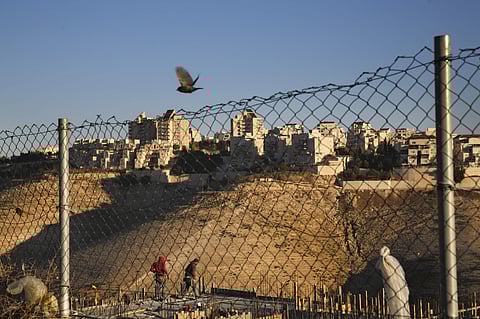 Palestinian laborers work at a construction site in a new housing project in the Israeli settlement of Maale Adumim, near Jerusalem, Tuesday, Feb. 7, 2017. (Photo | AP)