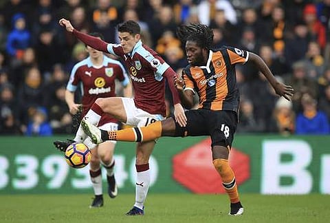 Burnley's Ashley Westwood, left, and Hull City's Dieumerci Mbokani fight for the ball during the English Premier League soccer match between Hull & Burnley at the KCOM stadium. | AP