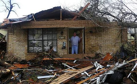 Greg Goza stands in the doorway of his 90-year-old mother-in-law's home after severe weather swept through a neighborhood in north central San Antonio, Monday, Feb. 20, 2017. His mother-in-law was not harmed, but the home is in shambles. (AP)