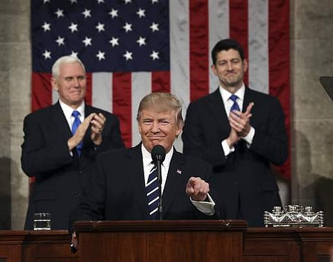 President Donald Trump, flanked by Vice President Mike Pence and House Speaker Paul Ryan, gestures on Capitol Hill in Washington, Tuesday, Feb. 28, 2017, before his address to a joint session of Congress. (Photo | AP)