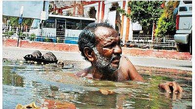 A scavenger cleans a gutter in front of the Egmore railway station | Express