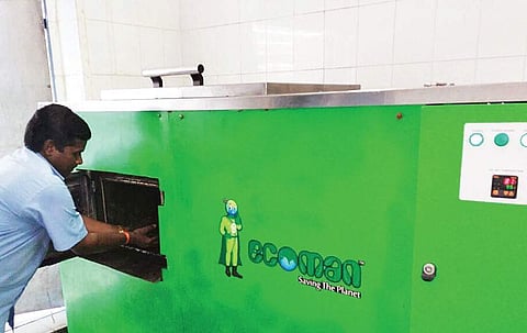 A hotel using on-site composting machinery to turn organic waste into manure