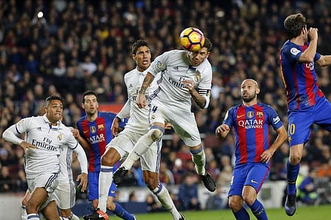 Real Madrid's defender Sergio Ramos (C) heads a ball to score the equalizer. (Photo | AFP)