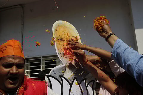 Bharatiya Janata Party supporters toss flowers on the cutout of Indian Prime Minister Narendra Modi as they celebrate winning seats in the state of Uttar Pradesh in Lucknow, India, Saturday, March 11, 2017. | AP