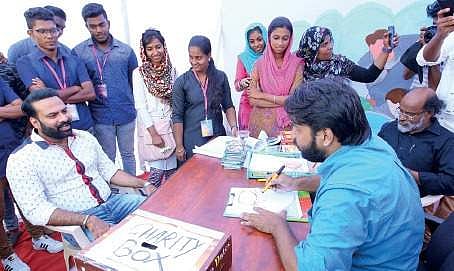 Cartoonist Ibrahim Badusha making a sketch of actor Tini Tom