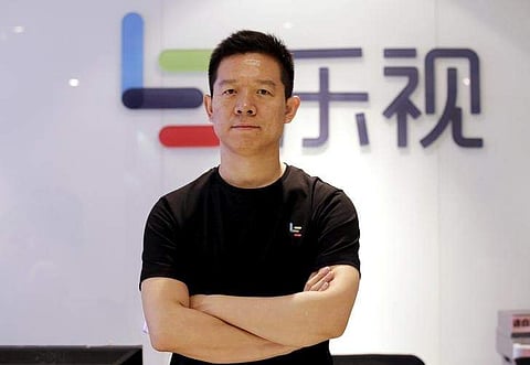 Jia Yueting, co-founder and head of Le Holdings Co Ltd, also known as LeEco and formerly as LeTV, poses for a photo in front of a logo of his company after a Reuters interview at LeEco headquarters in Beijing, China, picture taken April 22, 2016. | Reuter