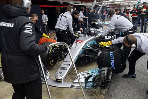 Mechanics work on the car of Mercedes driver Valtteri Bottas of Finland in the pit lane during a Formula One pre-season testing session at the Catalunya racetrack in Montmelo, outside Barcelona, Spain, Wednesday, March 1, 2017. | AP
