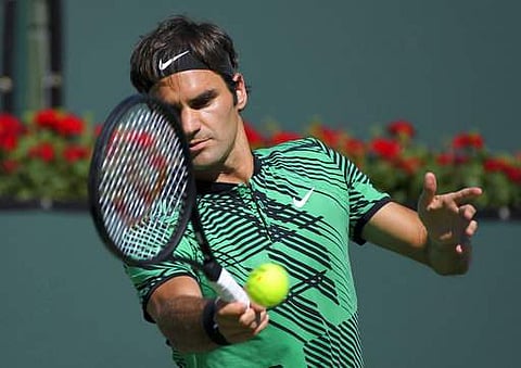 Federer claimed a tightly contested first set with a break in the 10th game, pushing Wawrinka into a forehand error to end a tense rally for a set point. | AP