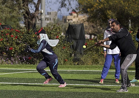 Palestinian women train for an all women's baseball game, on a soccer field, in Khan Younis, southern Gaza Strip.  (AP)
