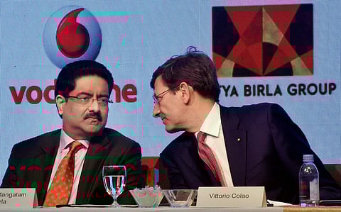 Aditya Birla Group chairman Kumar Mangalam Birla interacts with Chief Executive Officer of Vodafone Group Vittorio Colao during the announcement of merger between Vodafone India and Idea Cellular in Mumbai on Monday. | PTI