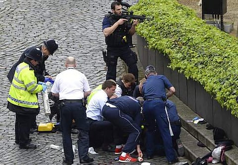 Emergency services at the scene outside the Palace of Westminster, London, Wednesday, March 22, 2017. London police say they are treating a gun and knife incident at Britain's Parliament 'as a terrorist incident until we know otherwise.' | AP