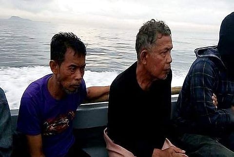 This photo provided by the Command Public Information Office, Western Mindanao Command, Malaysian hostages Tayudin Anjut, left, and Abdurahim Bin Sumas ride a boat after being rescued. (Photo | AP)