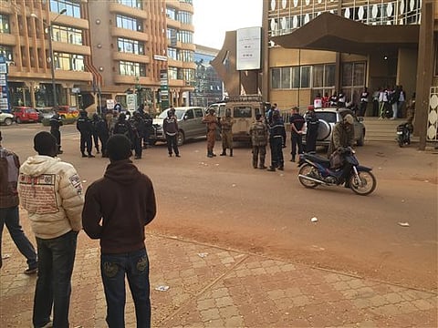 Security forces gather near the Hotel that was attacked by suspected militants in Ouagadougou, Burkina Faso, Saturday, Jan. 16, 2016. Burkina Faso and French forces rescued more people from a luxury hotel in Burkina Faso’s capital as they worked to take b
