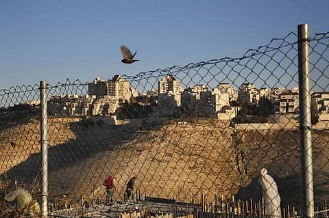 Palestinian labourers work at a construction site in a new housing project in the Israeli settlement of Maale Adumim, near Jerusalem. (File photo | AP)