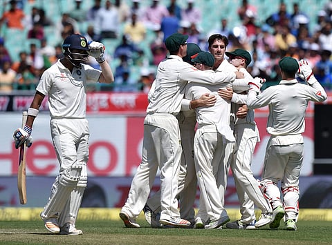 Pat Cummins of Australia celebrates the wicket of K L Rahul during the second day of last Test match against India at HPCA Stadium in Dharamsala on Sunday. | PTI