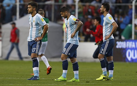 Argentina's Matias Caruzzo, left, Ever Vanegas, center, and Mateo Musacchio leave the field at the end of a 2018 Russia World Cup qualifying soccer match against Bolivia, at the Hernando Siles stadium in La Paz, Bolivia, Tuesday, March 28, 2017. Bolivia w