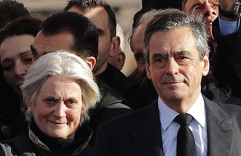 In this March 5, 2017 file photo, French conservative presidential candidate Francois Fillon and his wife Penelope smile after delivering his speech during a rally in Paris. | AP