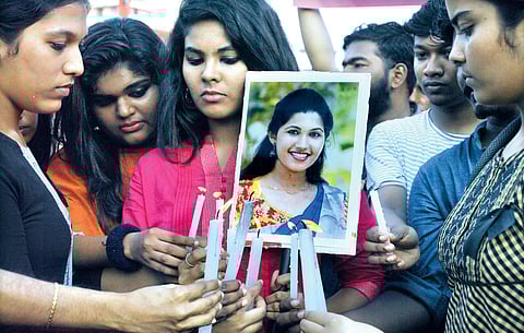 CA students pay homage to Mishel Shaji Varghese by lighting candles at Marine Drive in Kochi.| Express File Photo