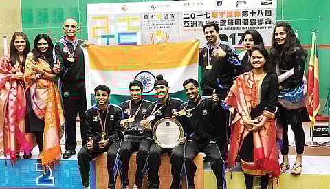 Cyrus Poncha (holding flag on right) with his wards at the Asian junior meet
