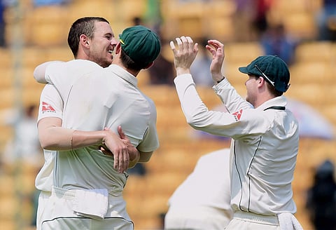 Australia's Josh Hazelwood with team mates celebrates the wicket of India's Ravindra Jadeja during the third day of the second test match at the Chinnaswamy Stadium in Bengaluru on Monday. | PTI