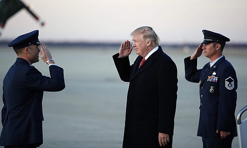 President Donald Trump salutes as he stands on the tarmac after disembarking Air Force One as he arrives Sunday, March 5, 2017 (Photo | AP)