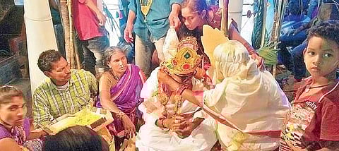 Unlike the regular practice, a bride tying Talibottu to the groom during a mass marriage programme at Nuvvalarevu  village of Vajrapukotturu mandal in Srikakulam district on Sunday  | Express