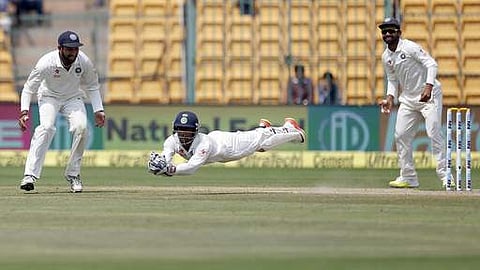 India's wicketkeeper Wriddhiman Saha, center, leaps in the air to catch the ball to dismiss Australia's Matthew Wade during the fourth day of their second test cricket match in Bangalore. AP