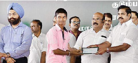 Chief Minister ‘Edappadi’ K Palaniswami giving away financial assistance to fishermen in the presence of Fisheries and Finance Minister D Jayakumar at a function held at R K Nagar in Chennai on Monday | d sampathkumar