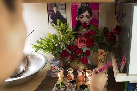 Part-time Win Win Aye paying respect to ancient spirits at her house on the outskirts of Yangon. (Photo | AFP)