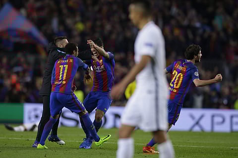 Barcelona's Neymar, Luis Suarez and Sergi Roberto celebrate with team mates at the end of the Champions League round of 16, second leg soccer match between FC Barcelona and Paris Saint Germain at the Camp Nou stadium in Barcelona, Spain, Wednesday March 8