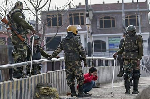 Indian paramilitary soldiers force a Kashmiri child to perform sit-up while holding his ear lobes, a common elementary school punishment in India | AP