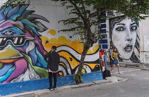 This picture taken on February 19, 2017 shows Dan Nguyen, a California-born Vietnamese artist who moved to Ho Chi Minh City about five years ago, working on his graffiti. (Photo | AFP)