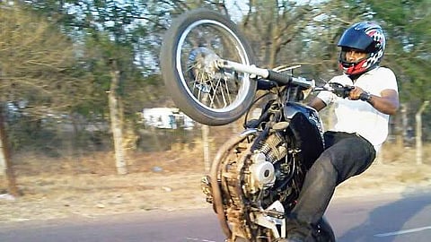 A youth performing a stunt on Bengaluru-Chennai national highway near Kolar.