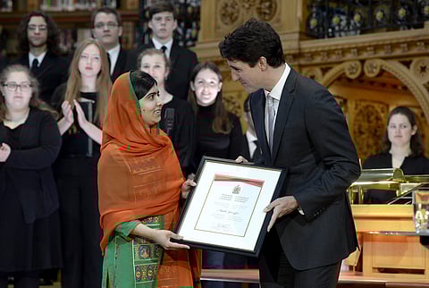Pakistani activist and Nobel Peace Prize winner Malala Yousafzai, left, is presented with an honorary Canadian citizenship by Prime Minister Justin Trudeau in on Parliament Hill in Ottawa on April 12, 2017. (Photo | AP)
