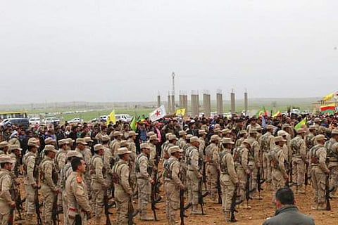 This photo provided by Hawar News Agency, a Kurdish-run news agency, which has been authenticated based on its contents and other AP reporting, shows fighters from the predominantly-Kurdish Syrian Democratic Forces attending the funeral procession of 18 o