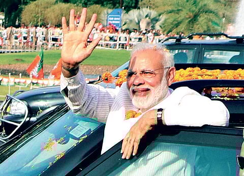 Prime Minister Narendra Modi waves at supporters at Raj Bhawan Square, Bhubaneswar, where he arrived for the BJP National Executive meeting, on Saturday | Shamim Qureshy