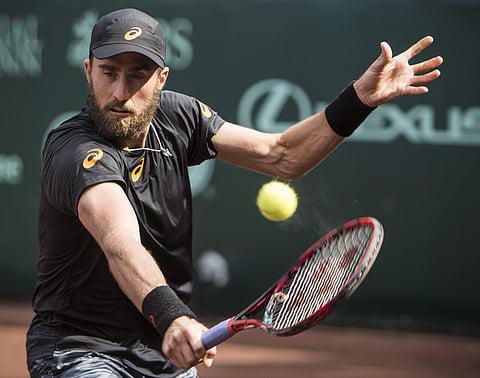 Steve Johnson hits a backhand against Thomaz Bellucci during final set of the championship singles match of the U.S. Men's Clay Court Championship tennis tournament at River Oaks Country Club. | AP