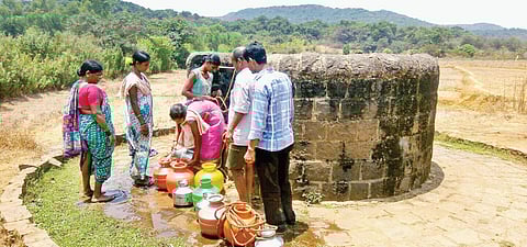 Villagers collecting water from the well, which is the only source of drinking water in Maan village of Khanapur taluk