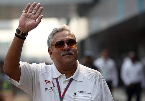Force India team principal Vijay Mallya waves in the paddock during the third practice session of the Indian F1 Grand Prix at the Buddh International Circuit in Greater Noida, on the outskirts of New Delhi, October 27, 2012.  | Reuters