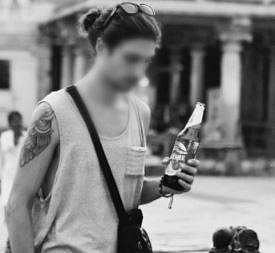 Foreign tourist sips beer in Hampi temple