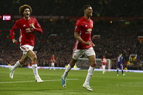 Manchester United's Marcus Rashford, right, celebrates scoring his side's second goal chased by his teammate Marouane Fellaini. (AP)