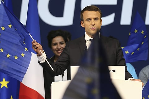 Independent centrist candidate Emmanuel Macron waves an European flag during a meeting in Nantes, Western France. | AP
