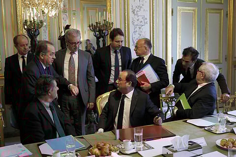 French President Francois Hollande, sitting at center, speaks with ministers and officials at the end of a defense council at the Elysee Palace in Paris, France, Friday, April 21, 2017.(AP)