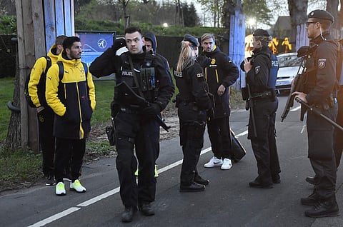 Dortmund's Marcel Schmelzer, third from right, talks to police officers outside the team bus after it was damaged in an explosion before the Champions League quarterfinal soccer match between Borussia Dortmund and AS Monaco. (AP)