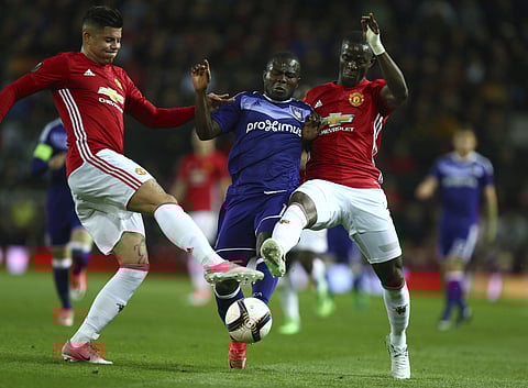 Manchester United's Marcos Rojo, left, and Eric Bailly compete for the ball with Anderlecht's Frank Acheampong, center, during the Europa League quarterfinal second leg soccer match at Old Trafford stadium. | AP