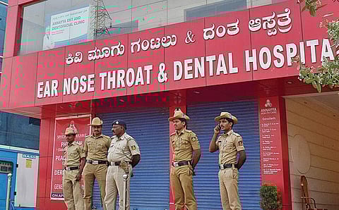 Police personnel deployed at Annayya Health Care in HSR Layout, which was shut following six-year-old Santhosh’s death on Saturday | Jithendra M