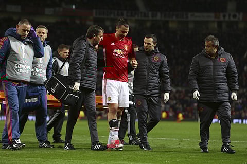 Manchester United's Zlatan Ibrahimovic, center, leaves the field with an injury during the Europa League quarterfinal second leg soccer match at Old Trafford stadium. | AP